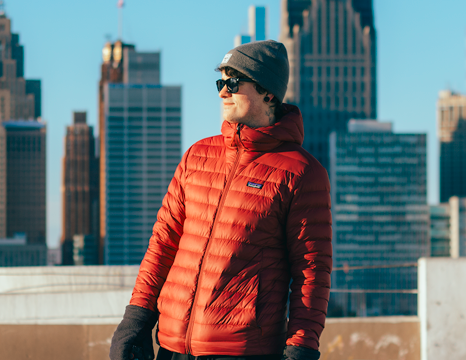 winter photo shoot of male model wearing a red patagonia coat.