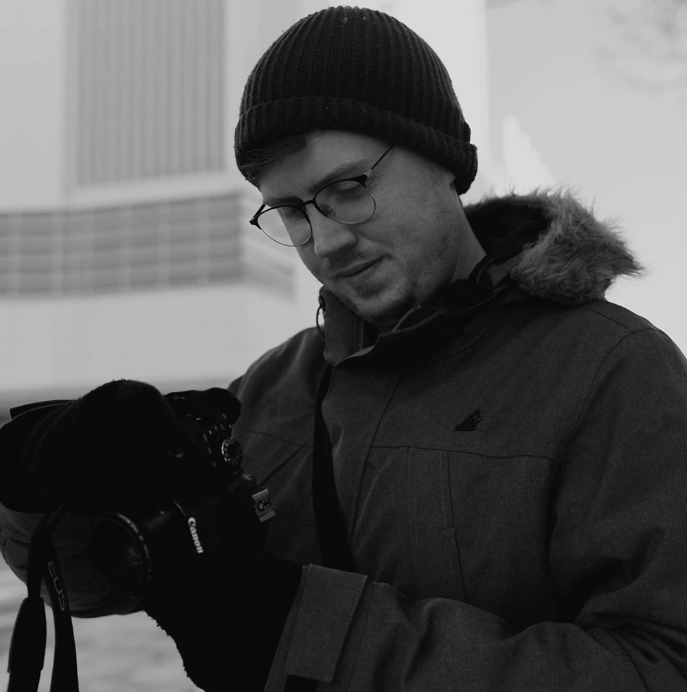 Photographer looking at his camera to review a picture
																												