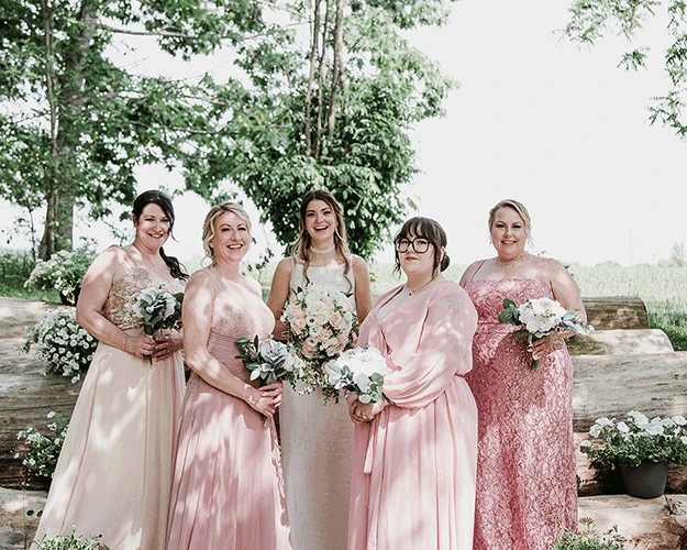 Bridesmaids posing for a photograph in the country